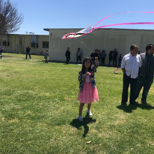 This student is excited to see her kite soar into the air!