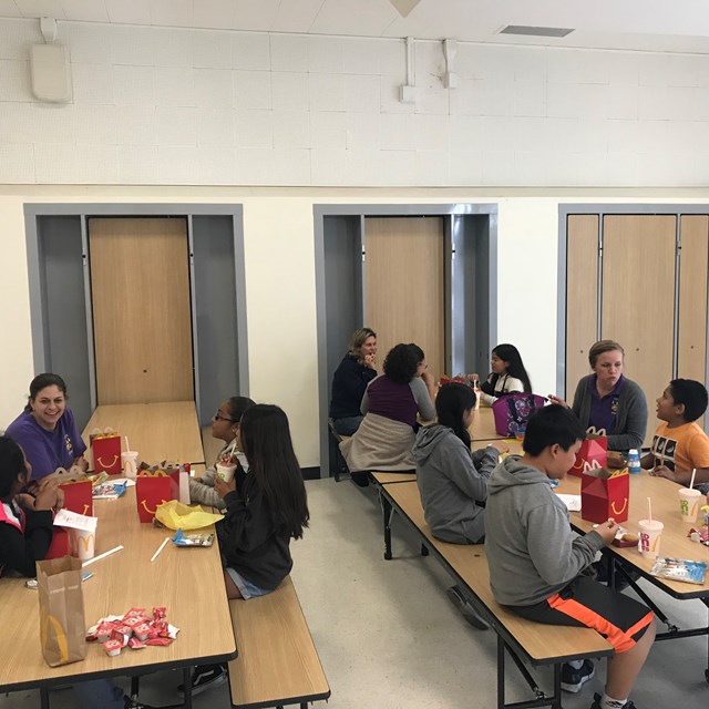 Students and teachers spend lunch together getting to know one another better as a special reward.