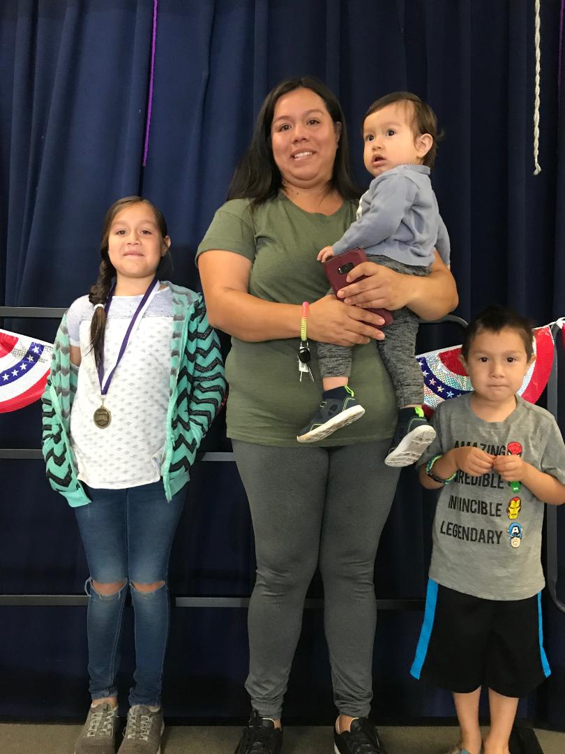 Students are recognized with their families and receive a medal for becoming English Proficient. 