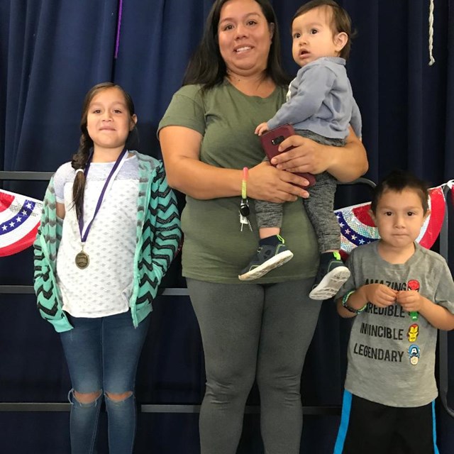 Students are recognized with their families and receive a medal for becoming English Proficient. 