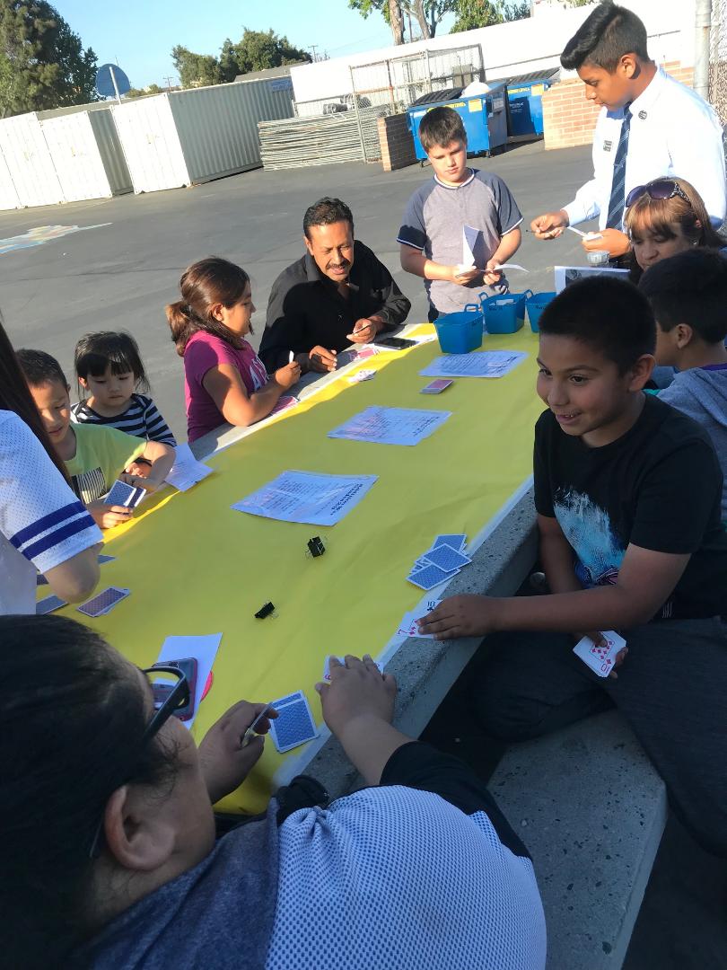 Students compete against their families and friends in math-inspired games using a deck of cards!