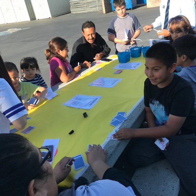 Students compete against their families and friends in math-inspired games using a deck of cards!