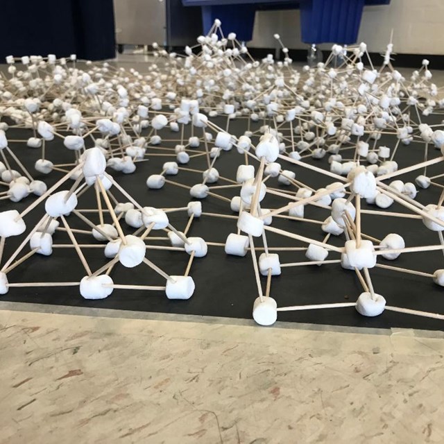 Students show off their engineering skills using toothpicks and marshmallows to create unique structures.