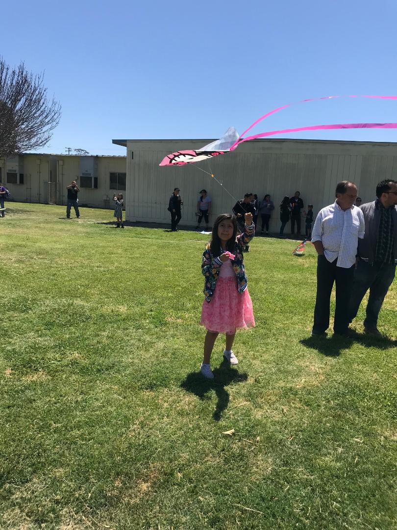This student is excited to see her kite soar into the air!